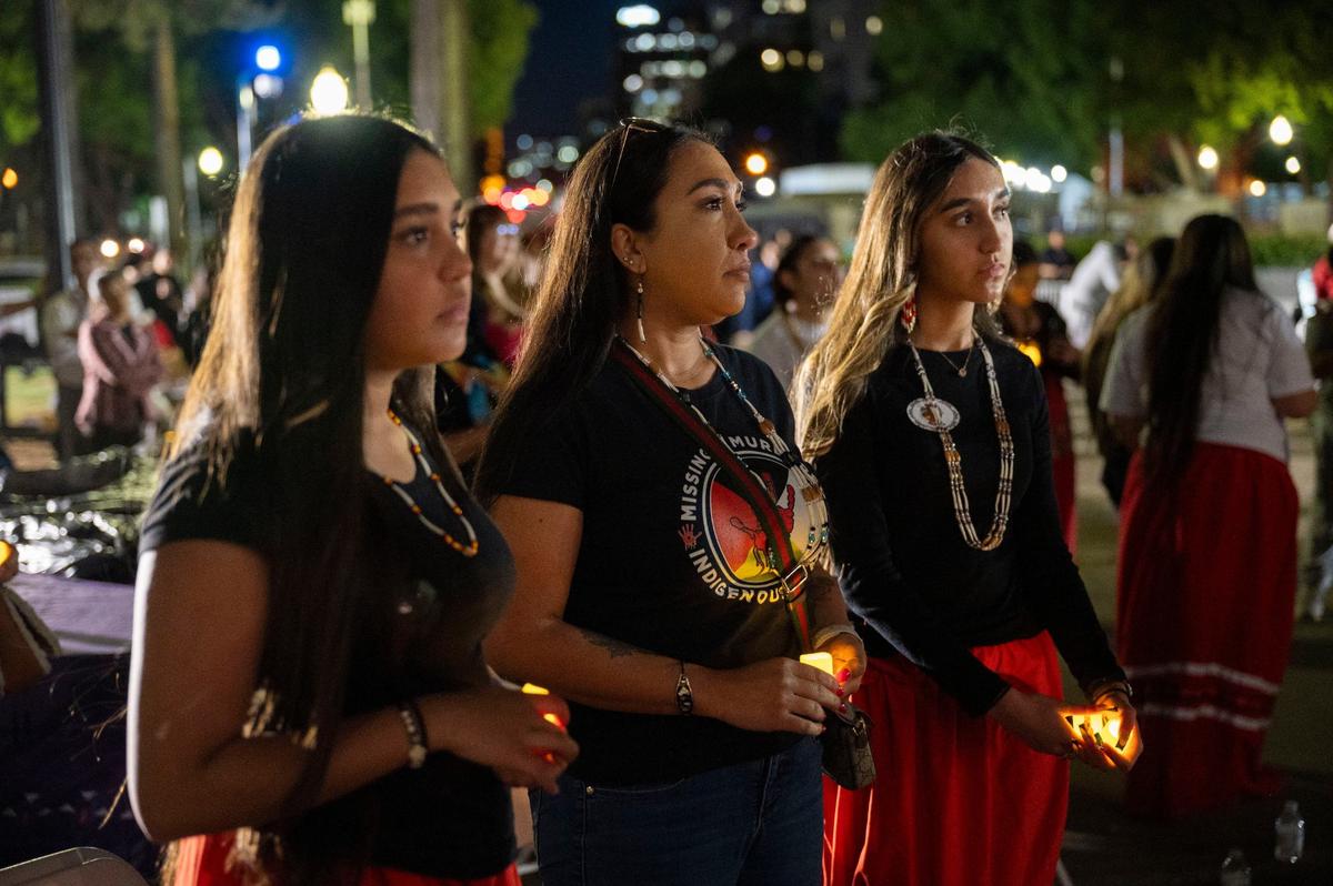 Alina Sanchez 16, left, stands with her mom, Angel Sanchez, center, and sister, Alyssa Sanchez, 13, during a candlelight vigil at the Capitol on May 1, 2024, for Missing and Murdered Indigenous People.