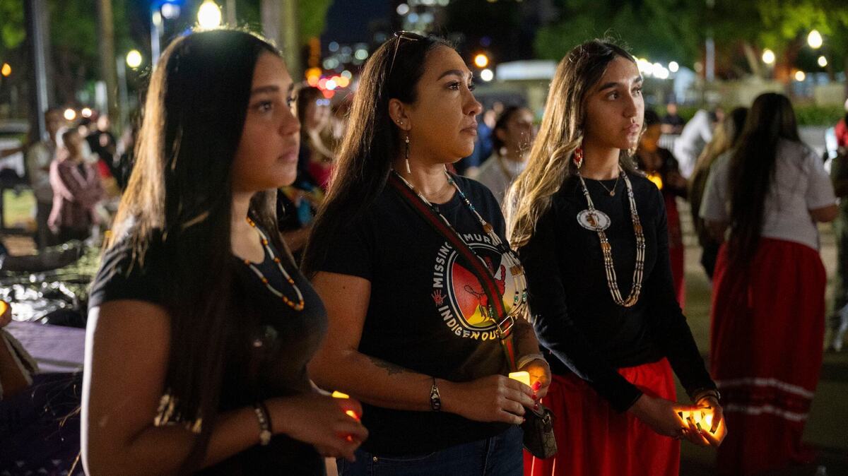 Alina Sanchez 16, left, stands with her mom, Angel Sanchez, center, and sister, Alyssa Sanchez, 13, during a candlelight vigil at the Capitol on May 1, 2024, for Missing and Murdered Indigenous People.