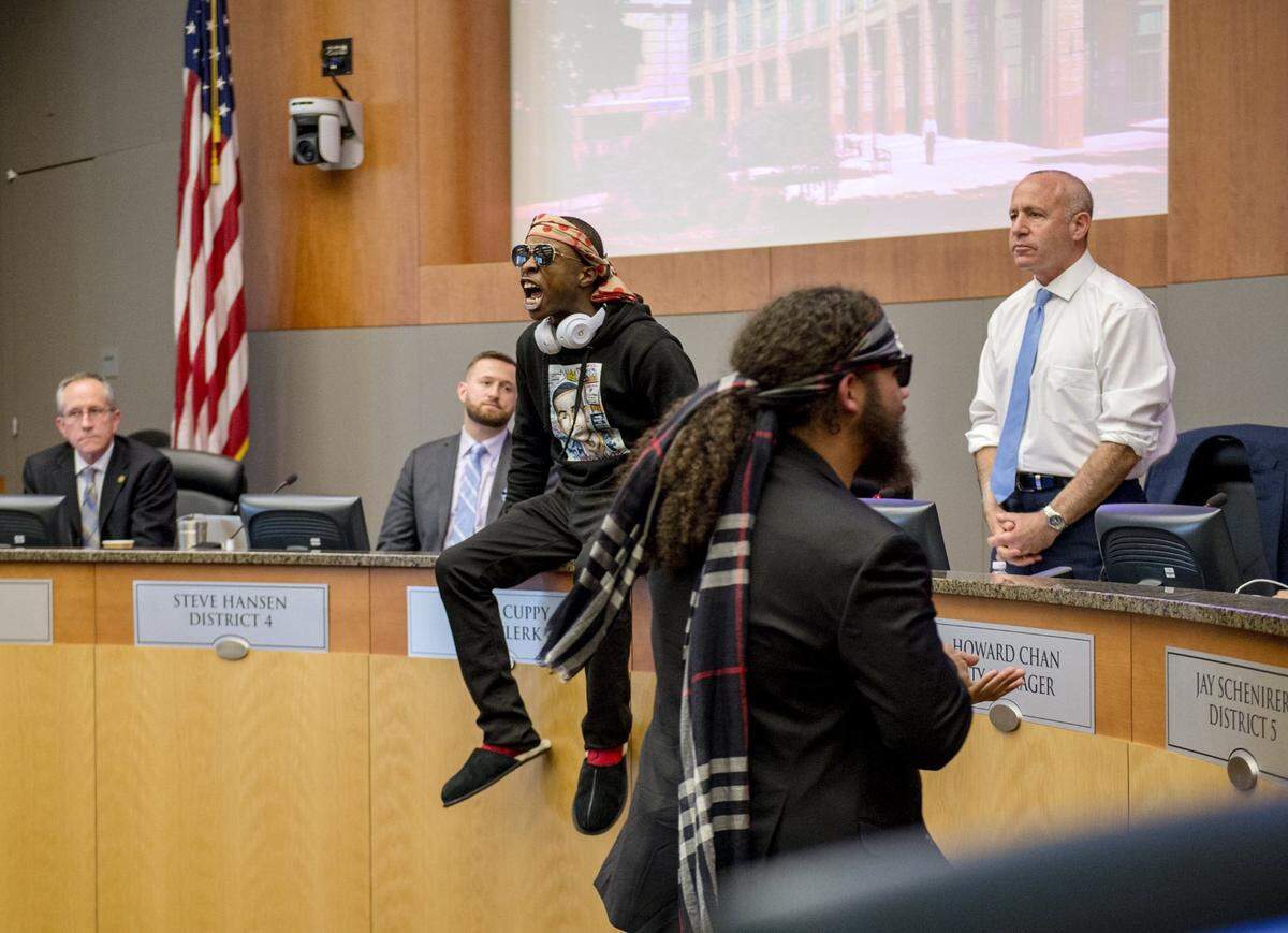 Stevante Clark, whose brother Stephon Clark was killed by Sacramento police earlier in the month, stormed into the packed Sacramento City Council chambers and jumped on the dias in front of Mayor Darrell Sternberg, briefly forcing the council to leave the chambers on March 27, 2018.