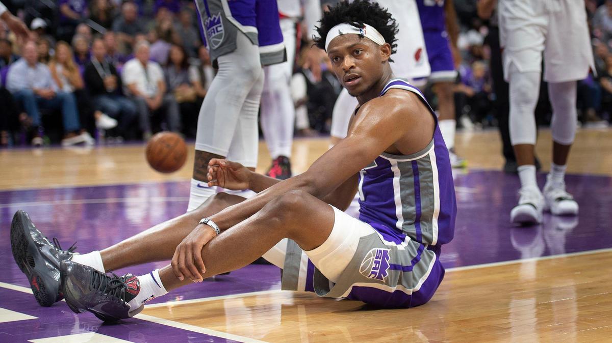 Sacramento Kings guard De’Aaron Fox sits on the floor after taking a hard hit while trying to score late in the fourth quarter during the Kings 122-112 loss to the Portland Trailblazers at the Golden 1 Center on Friday, October 25, 2019.
