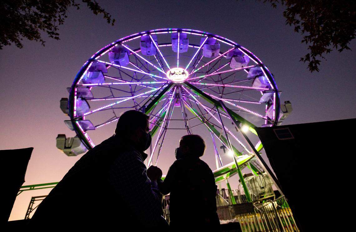 Sacramento City Councilman Steve Hansen, left, shares a moment with his 2-year-old son, Henry Hansen, as they prepare to ride the 65’ Waterfront Wheel during a preview event on Front Street on Wednesday, Oct. 28, 2020, in Old Sacramento. The new fixture is part of a multi-phased marketing campaign by the Downtown Sacramento Partnership titled “We are Downtown. Together.”