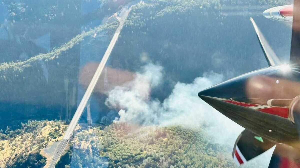 The Bridge Fire, seen from a Cal Fire aircraft on Saturday, burned three acres before being contained. Authorities say two suspects were being sought in connection with the blaze, which was ruled arson.