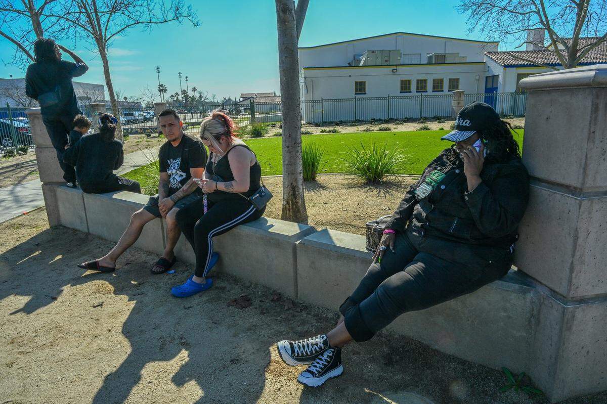 Debra Cummings, co-leader of a neighborhood group Third Party Homicide, right, was one of the first on the scene to alert parents after a student was shot in the arm at Grant High School on Tuesday. At left parents wait for the children to be released from lock down.