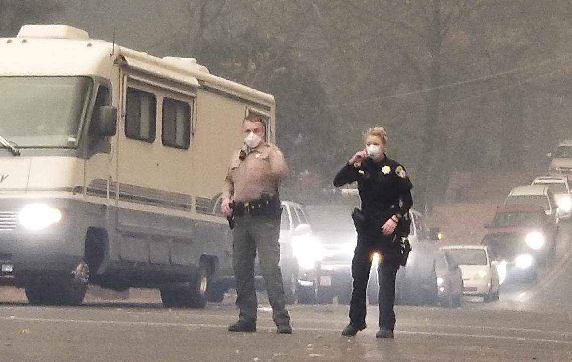 Butte County Sheriff Kory Honea and his daughter Kassidy Honea, a Paradise police officer, direct traffic the morning of the Camp Fire.