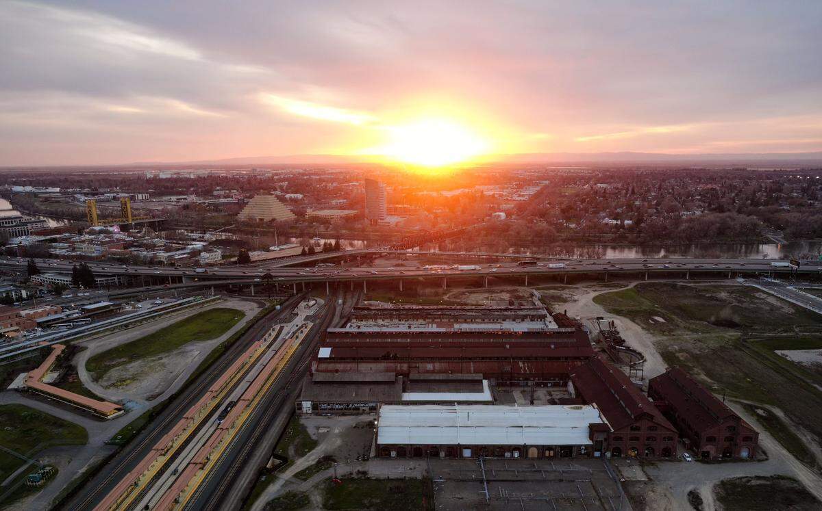 A view of the Sacramento’s Railyards development is photographed with a drone at sunset on Tuesday evening, March 2, 2021.