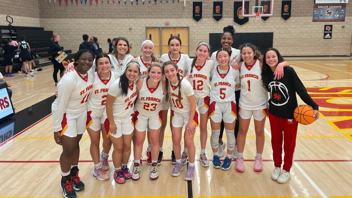 St. Francis players celebrate after clinching the Delta League championship with a 63-25 victory over Sheldon on Wednesday, Feb. 8, 2023.