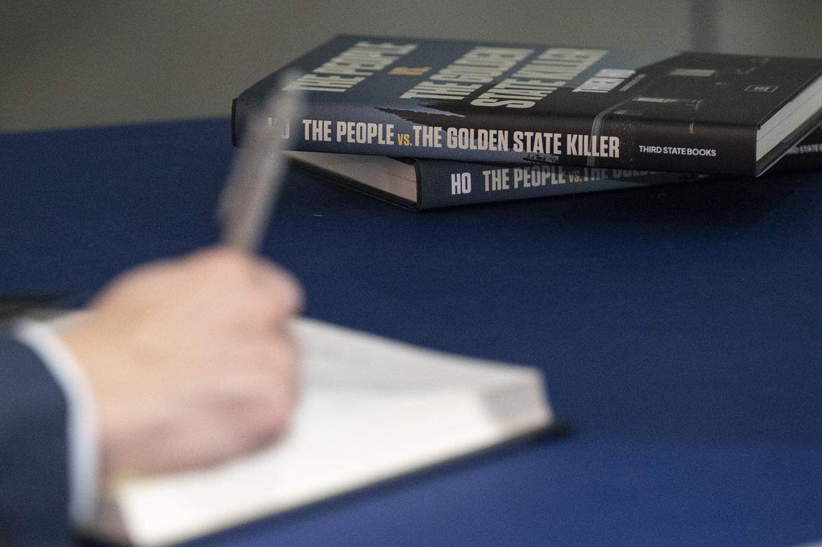 Sacramento County District Attorney Thien Ho signs copies of his book “The People vs. the Golden State Killer” after a live Q&A at The Sacramento Bee’s office in Sacramento on Tuesday, Dec. 9, 2025.