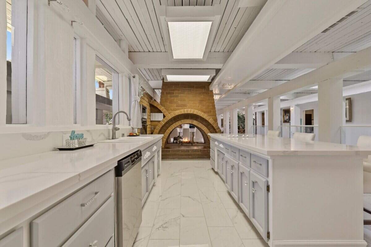 The Fair Oaks home has a pass-through fireplace adorning the kitchen area.
