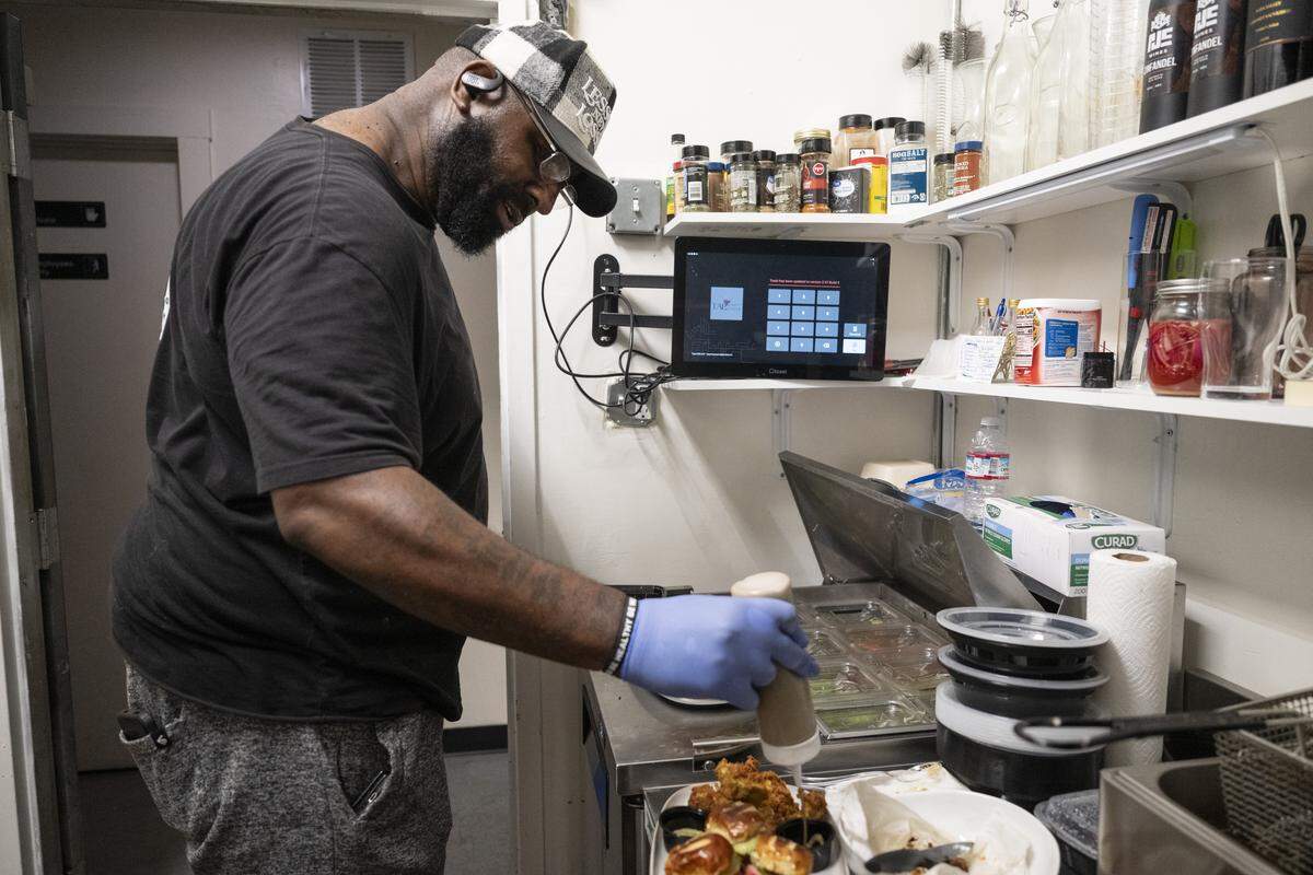 Elevated Eats owner Carlton Brown serves out sauce with his oyster mushroom slider sampler at TAP Wine Lounge in Sacramento on Thursday, Dec. 4, 2025.