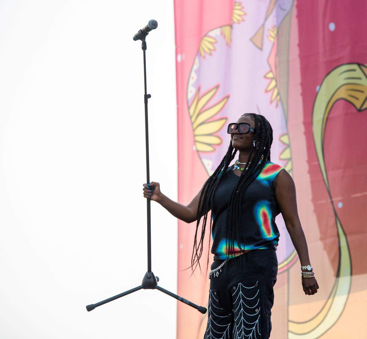 Ama Serwah Genfi, a Ghanaian-American singer known professionally as Amaarae, holds the mic up to the audience while performing at Lost in Riddim on Saturday, Oct. 1, 2021, near the Sacramento Railyards.
