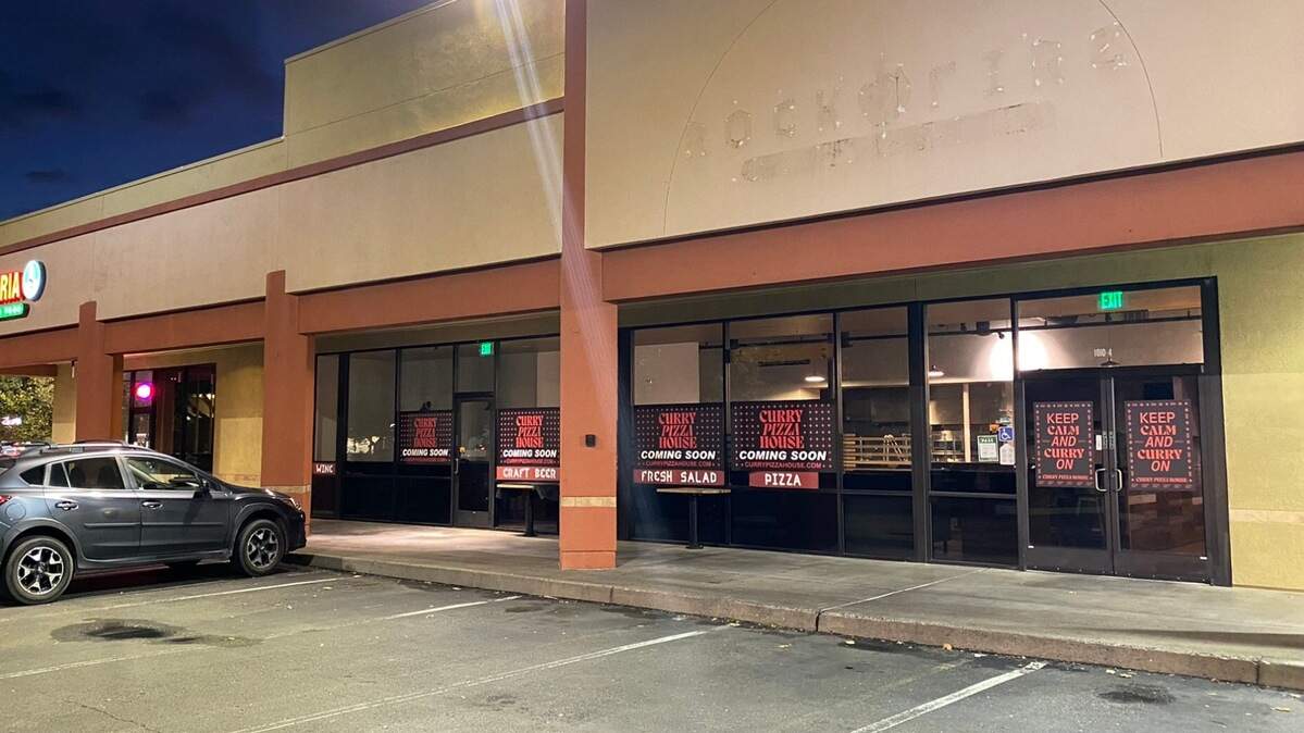 Signs line the windows of 1010 Riley St., Suite 4, advertising Curry Pizza House’s new location on Oct. 12, 2022. The space is where Rock-N-Fire Pizza, Burgers and Wings used to be. Curry Pizza House offers Indian-style pizza, other pizza, salad, craft beer and wine.
