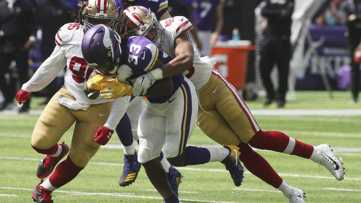 49ers linebacker Fred Warner, right, forces Minnesota Vikings running back Dalvin Cook to fumble during Sunday’s game in Minneapolis. Warner had a game-high 12 tackles, including one for loss, a pass breakup and forced fumble in the 24-16 loss.