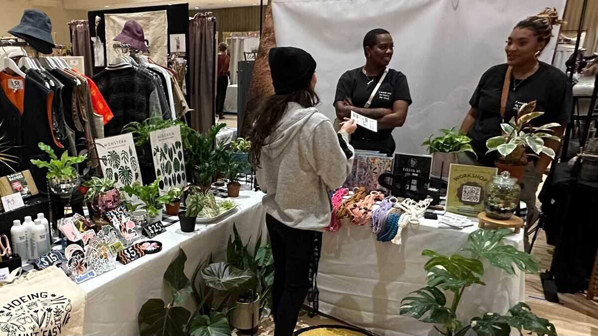 Mikaela Baker, center, and Gericka Allen with Sac City Stems talk with a shopper at the Makers Mart holiday craft event on Saturday, Dec. 9, 2023.