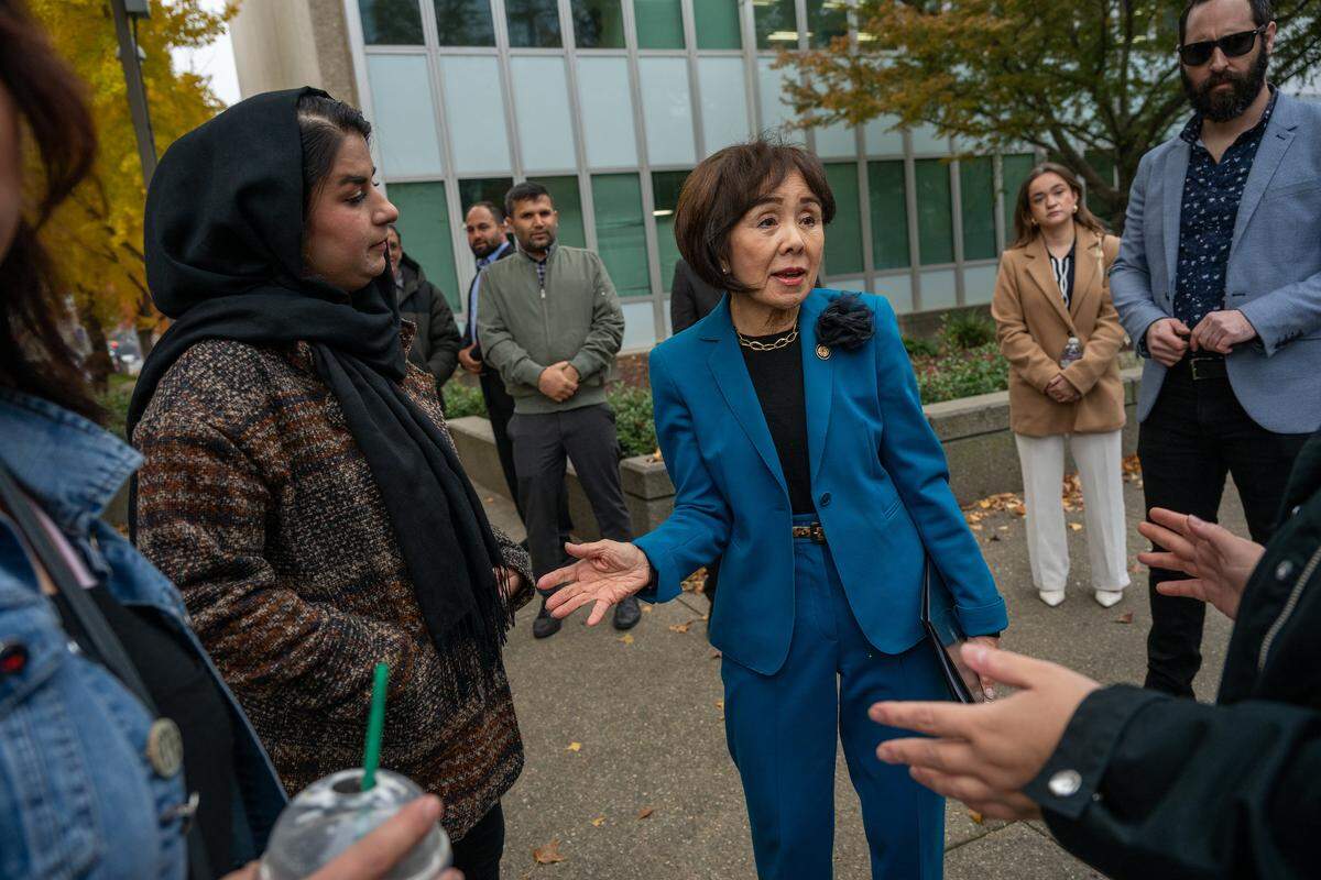 Congresswoman Doris Matsui, D-Sacramento, center, speaks with concerned citizens denouncing ICE’s targeting of Afghans at a press event in front of the John E. Moss federal building in Sacramento on Friday.