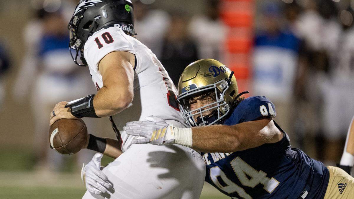 UC Davis Aggies defensive lineman Jacob Psyk (94) knocks the ball out of the hands of Southern Utah Thunderbirds quarterback Bronson Barron (10) in the backfield in the second half on Saturday, Sept. 20, 2025 in Davis.