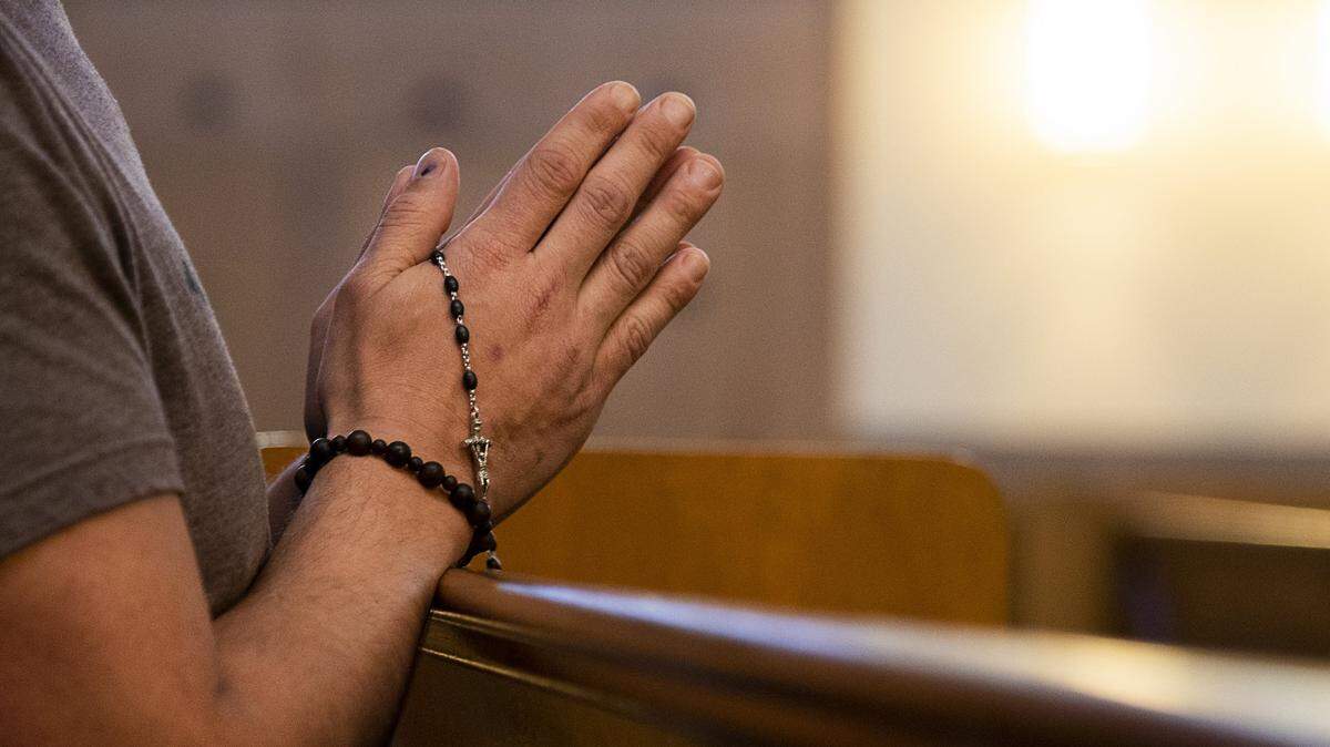 Parishioner Joshua Figueroa kneels at St. Ignatius Loyola Parish for prayer and quiet meditation during the coronavirus pandemic outbreak on Friday, March 20, 2020 in Sacramento.