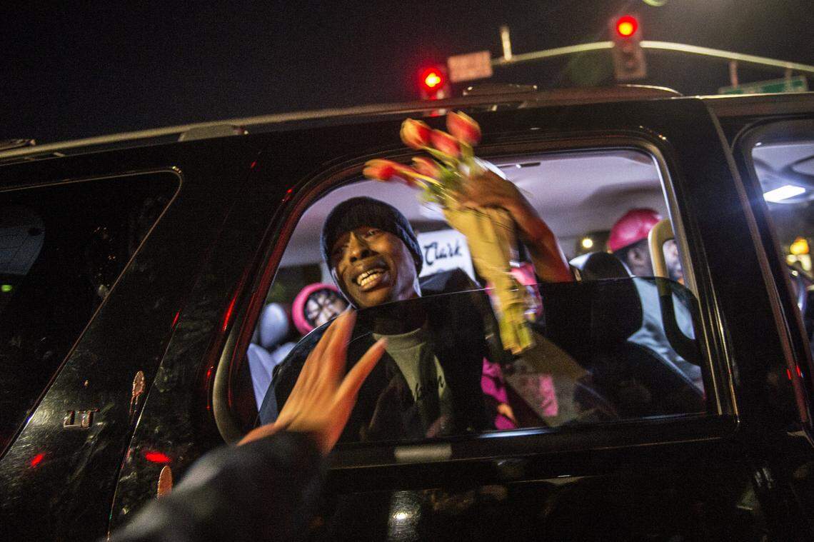 Stevante Clark the brother of Stephon Clark is given flowers as he stopped in an SUV at the intersection of Florin and 29th Street during a vigil for his brother in Sacramento, Calif., on Fri., March 23, 2018. His brother Stephon was unarmed when he was shot and killed by Sacramento Police in his grandparents back yard.