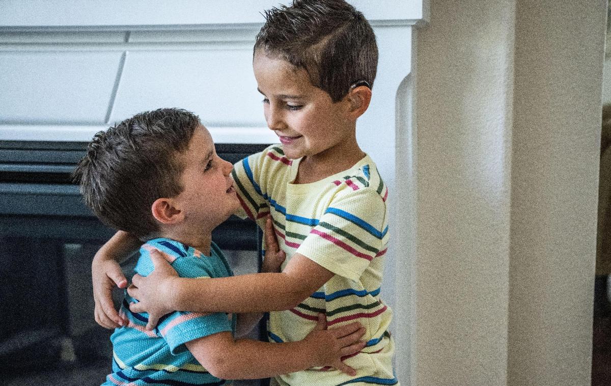 Jake Janes, 6, who has been living with impaired hearing since birth, hugs his younger brother Luke, 2, at home in Rocklin in July. His parents Nick and Christina Janes have been lobbying for Senate Bill 635, which would require insurance companies to cover hearing aids for children like Jake.
