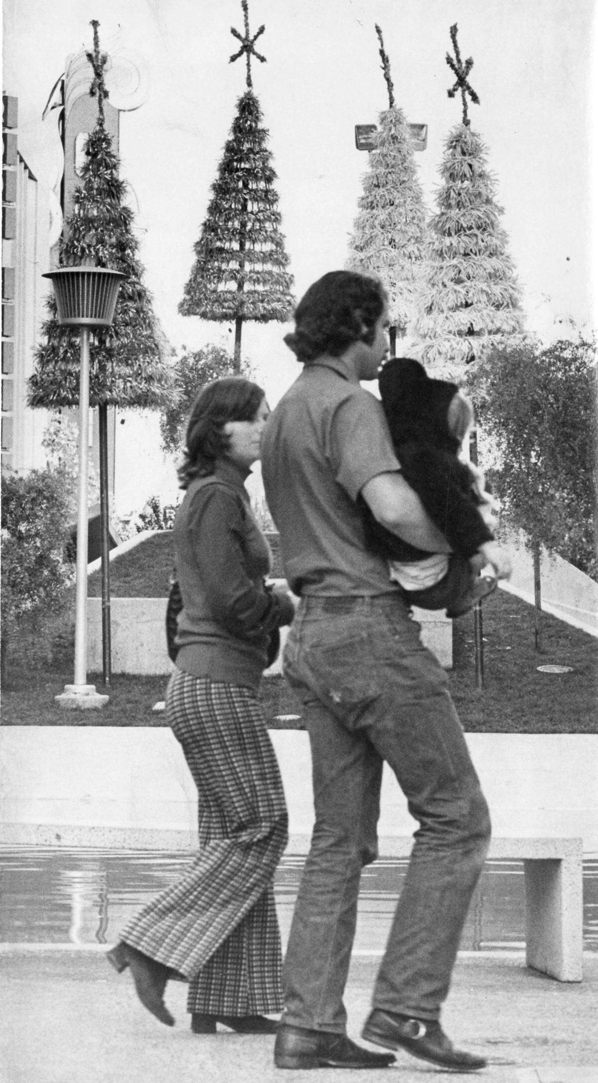A couple walks past Christmas decorations on the K Street Mall near the Crest Theatre in November 1973. The decorations will be lit despite concerns about an energy shortage. The Sacramento Downtown Association projected a 75% energy savings by turning them on for six hours in the evenings, instead of the past practice of illuminating them 24 hours per day.