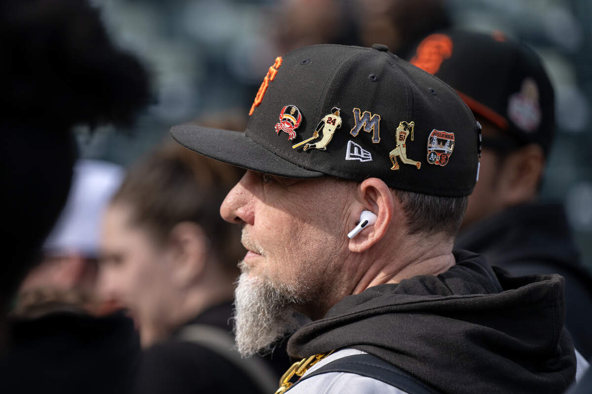 Mike Airolbi of Vallejo dons a San Francisco Giants hat filled with buttons commemorating the team’s history at FanFest, at Sutter Health Park on Saturday in West Sacramento.