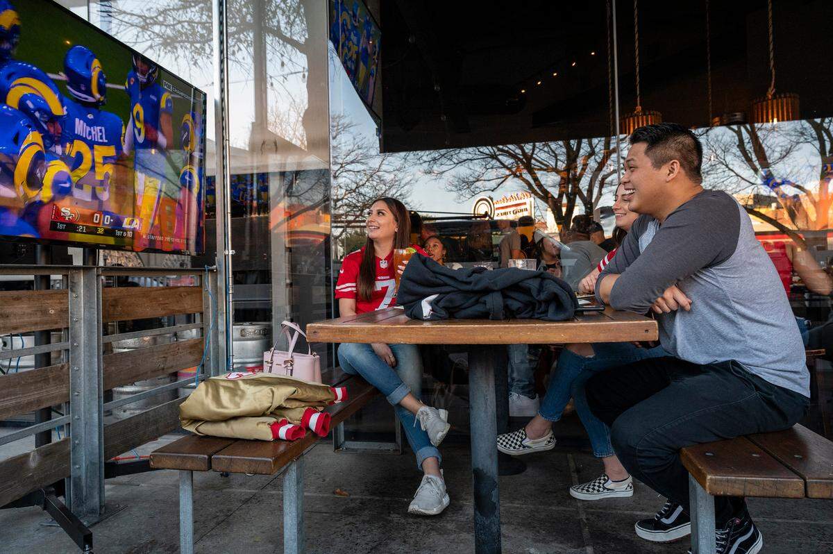Fans watch the NFC Championship game from the outdoor patio at Public House Downtown in 2022. The pub’s popular game-day gatherings will come to an end following its announced closure.