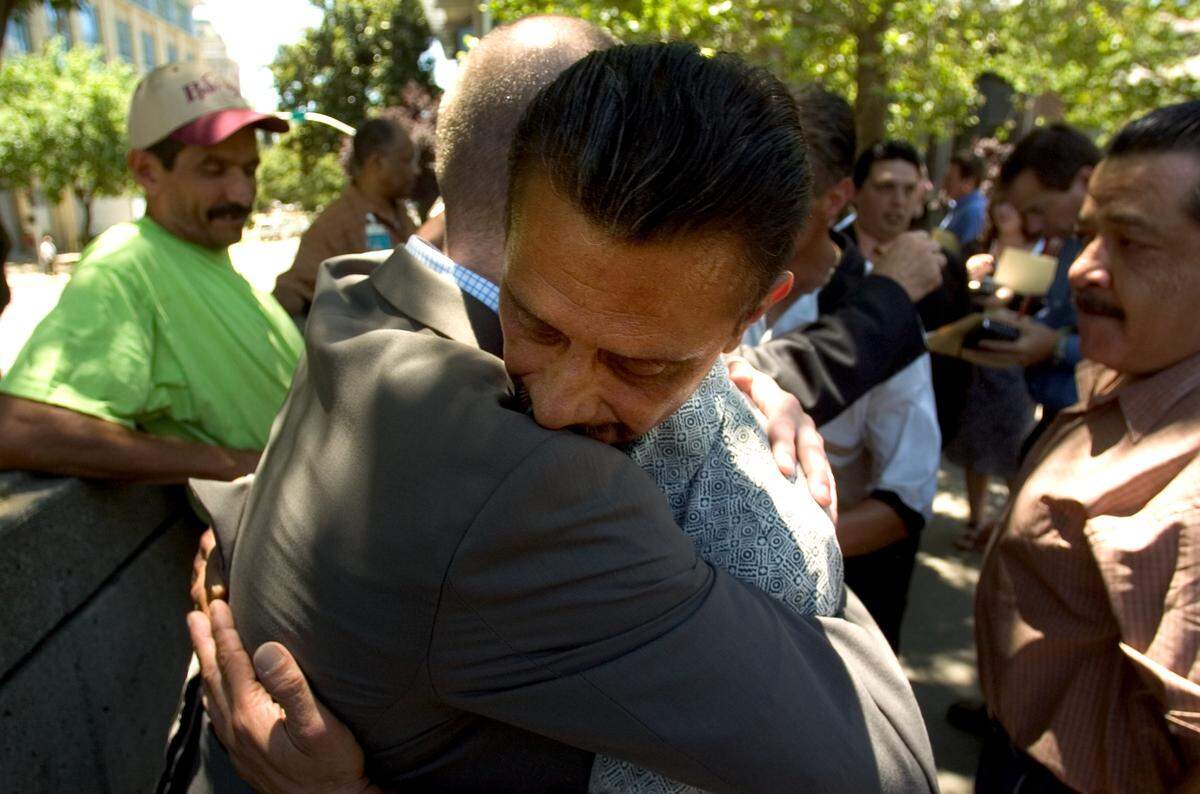 JUMP -- Louis Lopez, who was abused by a priest in his childhood, embraces his lawyer Joe George after learning the Roman Catholic Diocese of Sacramento will pay $35 million to settled clergy abuse lawsuits Wednesday, June 29, 2005. Bishop William Weigand has offered to meet personally with each of the victims to offer an apology on behalf of the diocese and to support spiritual healing. The Sacramento Bee / Carl Costas