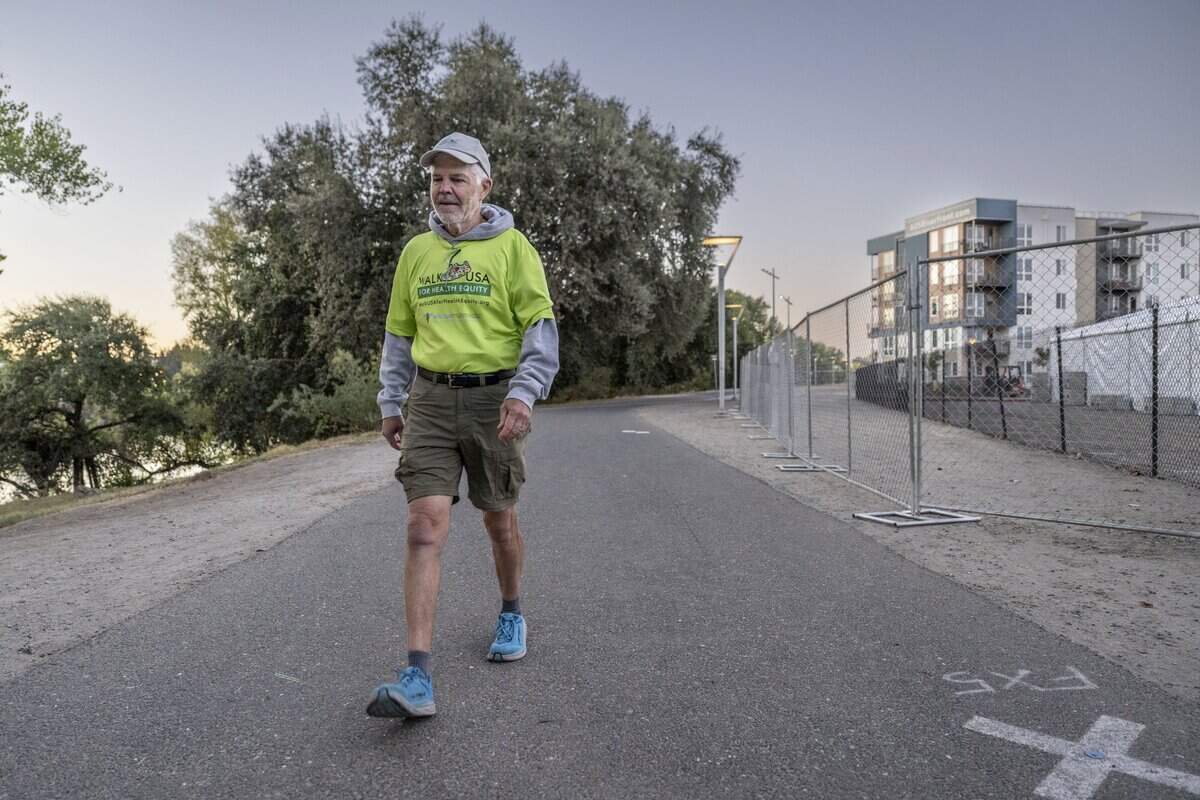 Dennis Godby of West Sacramento walks to work in Sacramento earlier this month. Godby said he recently he completed a five-year, 3,450-mile walk across the country to promote health equity.