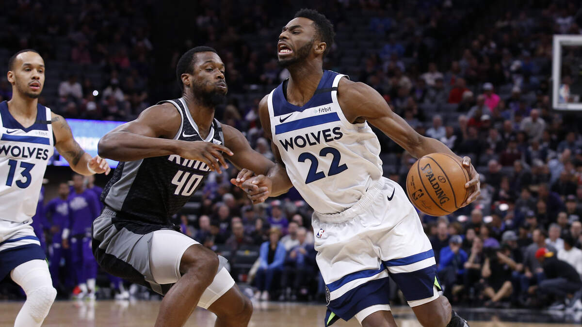 Minnesota Timberwolves guard Andrew Wiggins drives against Sacramento forward Harrison Barnes on Monday.