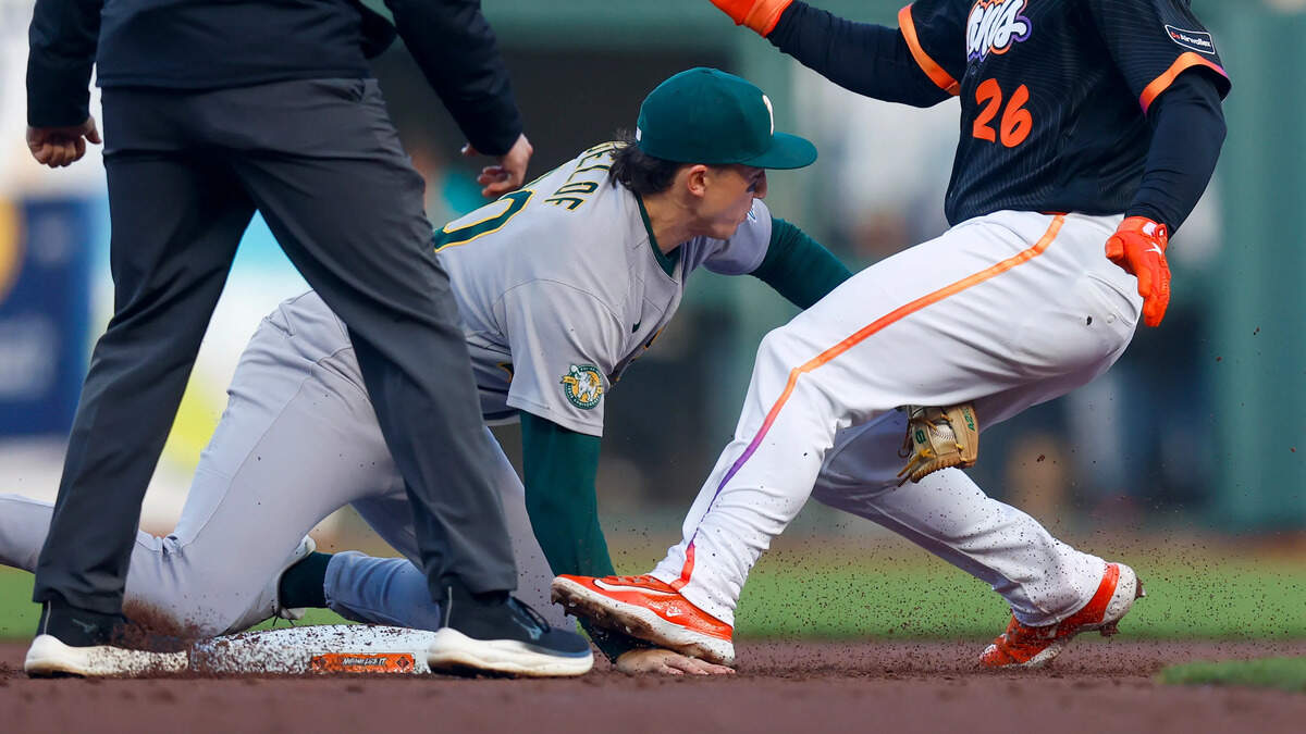The San Francisco Giants’ Matt Chapman steps on the hand of the Athletics’ Zack Gelof after being tagged out at second base in the second inning Tuesday at Oracle Park in San Francisco.