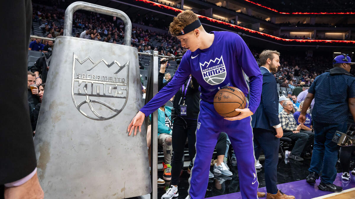 Sacramento Kings guard/forward Kevin Huerter (9) hits the large cowbell while warming up before their NBA basketball game against the San Antonio Spurs on Thursday, Nov. 17, 2022, at Golden 1 Center in Sacramento.