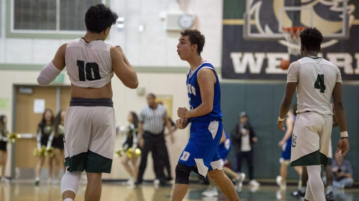 Davis guard Cody Taylor, middle, pumps his fists as he walks past Monterey Trail’s Christian Dabandan (10) and Kevin Adams Jr. (4) after the Blue Devils’ 58-57 victory over the Mustangs in Wednesday night’s Sac-Joaquin Section Division I opener in Elk Grove. Taylor led Davis with 10 points. He also carries a 4.5 grade-point average.