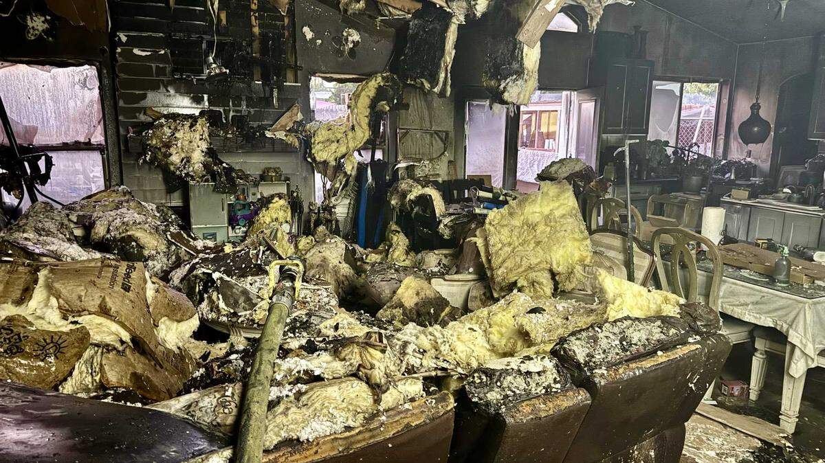 Fire damage is visible in the living room of a south Sacramento home on the 8500 block of Fairlawn Court on Tuesday, Aug. 19, 2025. Firefighters say a mother’s quick actions helped get her family of six out safely after waking to the sound of a boom and seeing flames push through the front door.