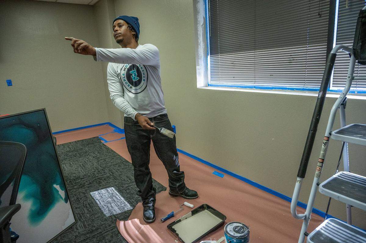 Sidney Randle gives instruction to an apprentice while he was painting at the People Working Together training facility in Sacramento on Tuesday, March 25, 2025. He said the PWT program gave him experience in the construction trade that helped him find work after being incarcerated for 10 years.