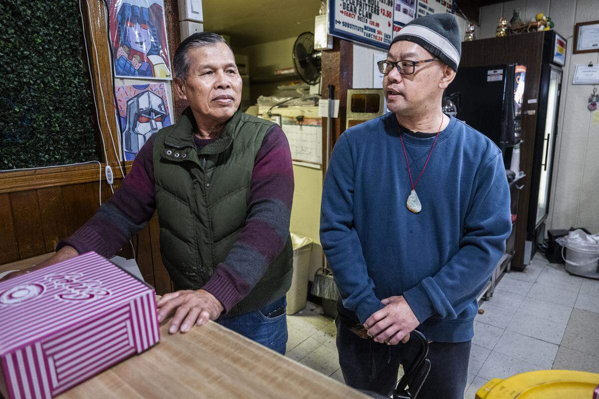 Don Thach, the new owner of Broadway Donuts  in Sacramento, stands with outgoing owner Josan So on Friday. The donut shop was scheduled to close until Thach stepped up to keep it open after So suffered a stroke.