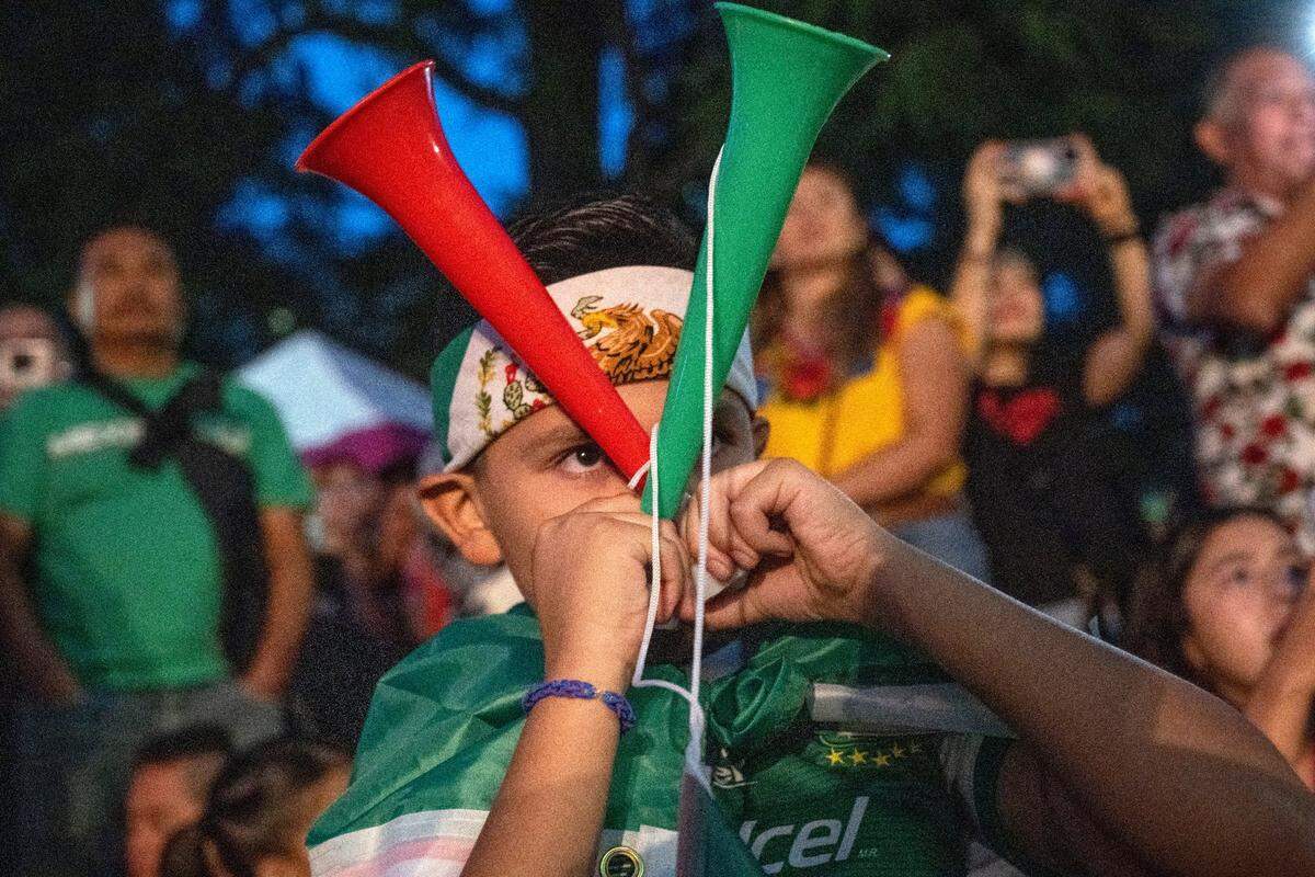 Axel Liam Perez, 8, of Sacramento blows a horn during a celebration of the Mexican Day of Independence on the west steps of the state Capitol on Thursday, Sept. 15, 2022.