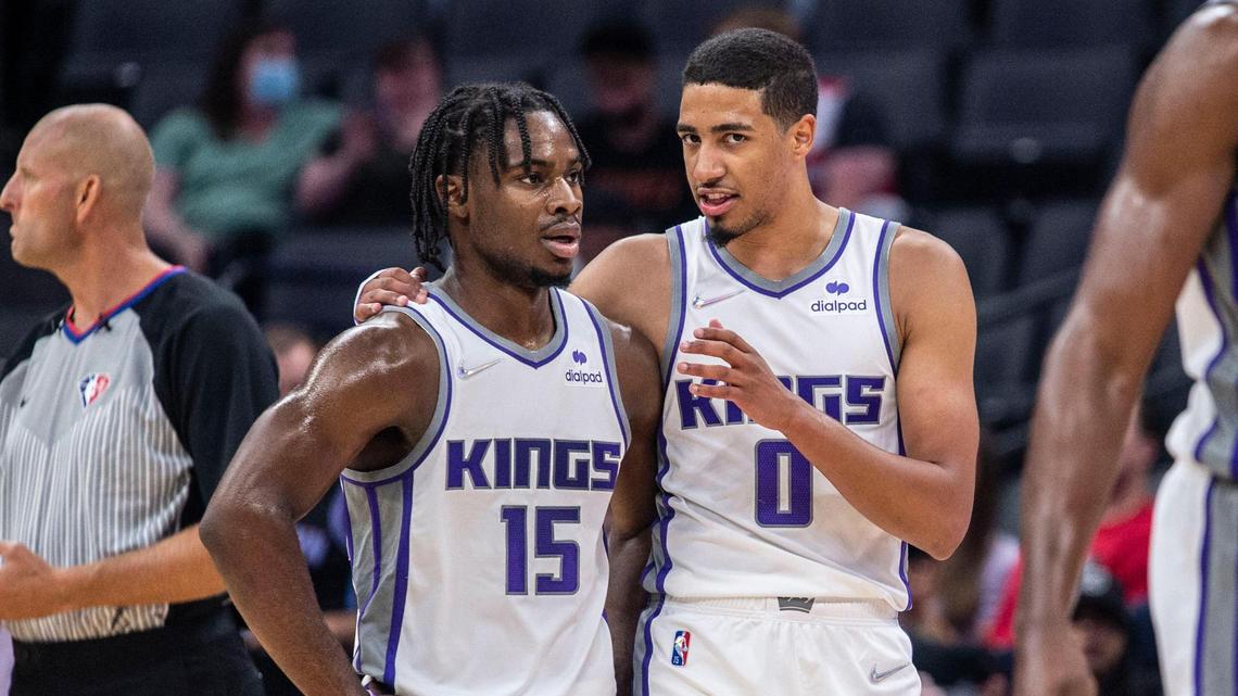 The Sacramento Kings’ Davion Mitchell (15) talks with teammate Tyrese Haliburton (0) during the first quarter of an NBA preseason game on Monday, Oct. 4, 2021 at Golden 1 Center in Sacramento.