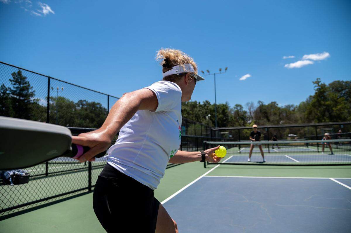 Joan Cardinet serves during a pickleball game at the Sacramento Open, the first USA Pickelball-sanctioned tournament to be held in the region, at Rusch Community Park in Citrus Heights on Friday. Men and women of all ages competed during the weekend tournament.