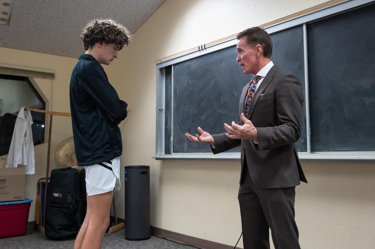 Waldorf Waves coach Dean Stark talks with guard Mickey Early (2) before a game in December.