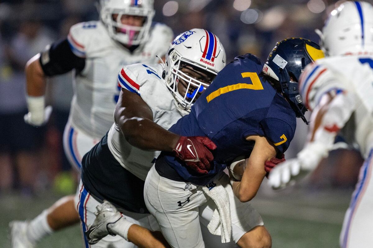 The Folsom Bulldogs’ Josiah Sharma (71) brings down Oak Ridge Trojans quarterback Phoenix Hester (7) in October.