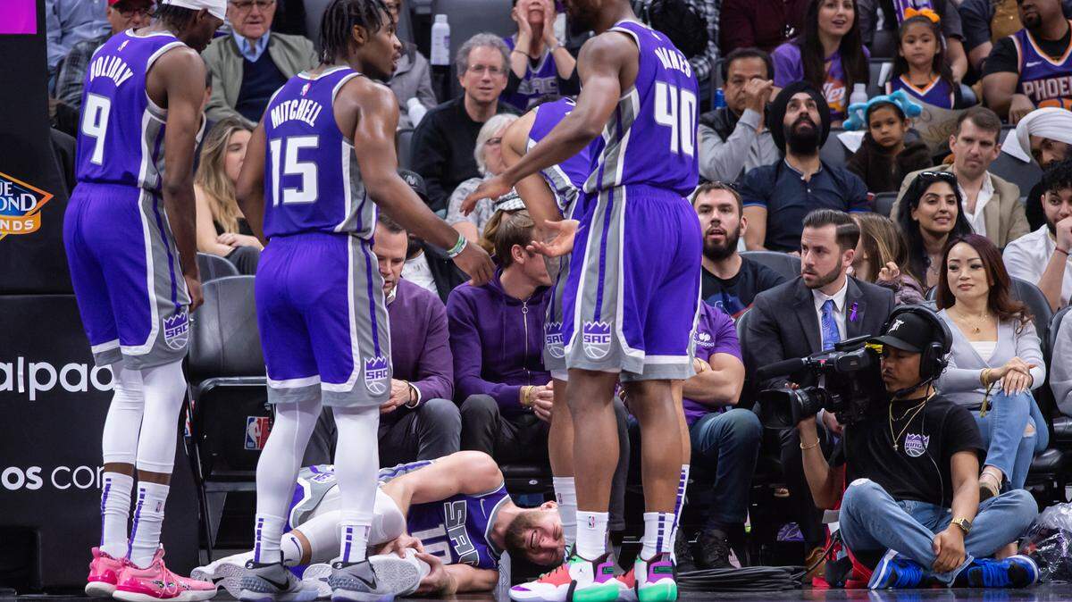 Sacramento Kings forward Domantas Sabonis (10) goes down hard after a charge is called on him during the fourth quarter on Sunday, March 20, 2022 during an NBA basketball game at the Golden 1 Center in Sacramento. Sabonis returned to the game after a timeout was called. The Suns win 127-124 in overtime.