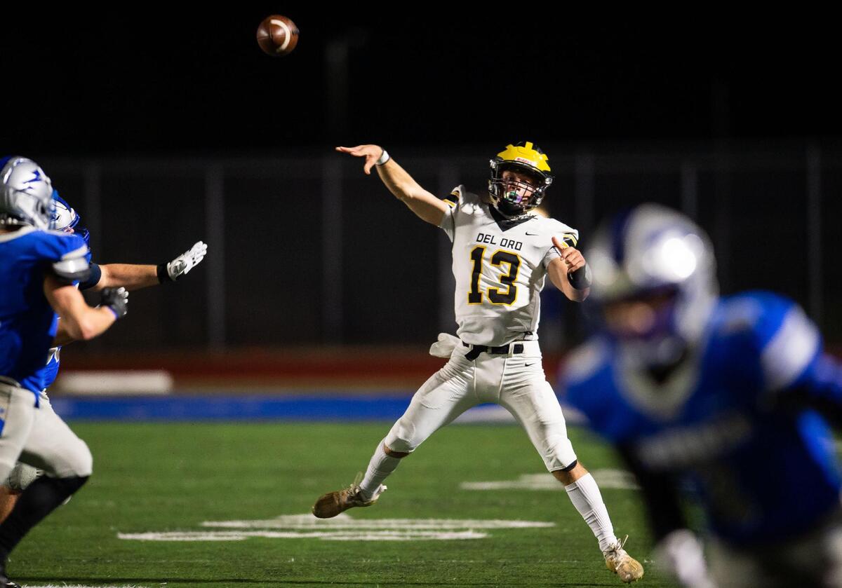 Del Oro quarterback Ryan Lewis scrambles, avoids being sacked and completes a pass to the sideline during the second quarter against Rocklin at the high school football game Friday, March 19, 2021, in Rocklin. Rocklin beat rival Del Oro 29-21.