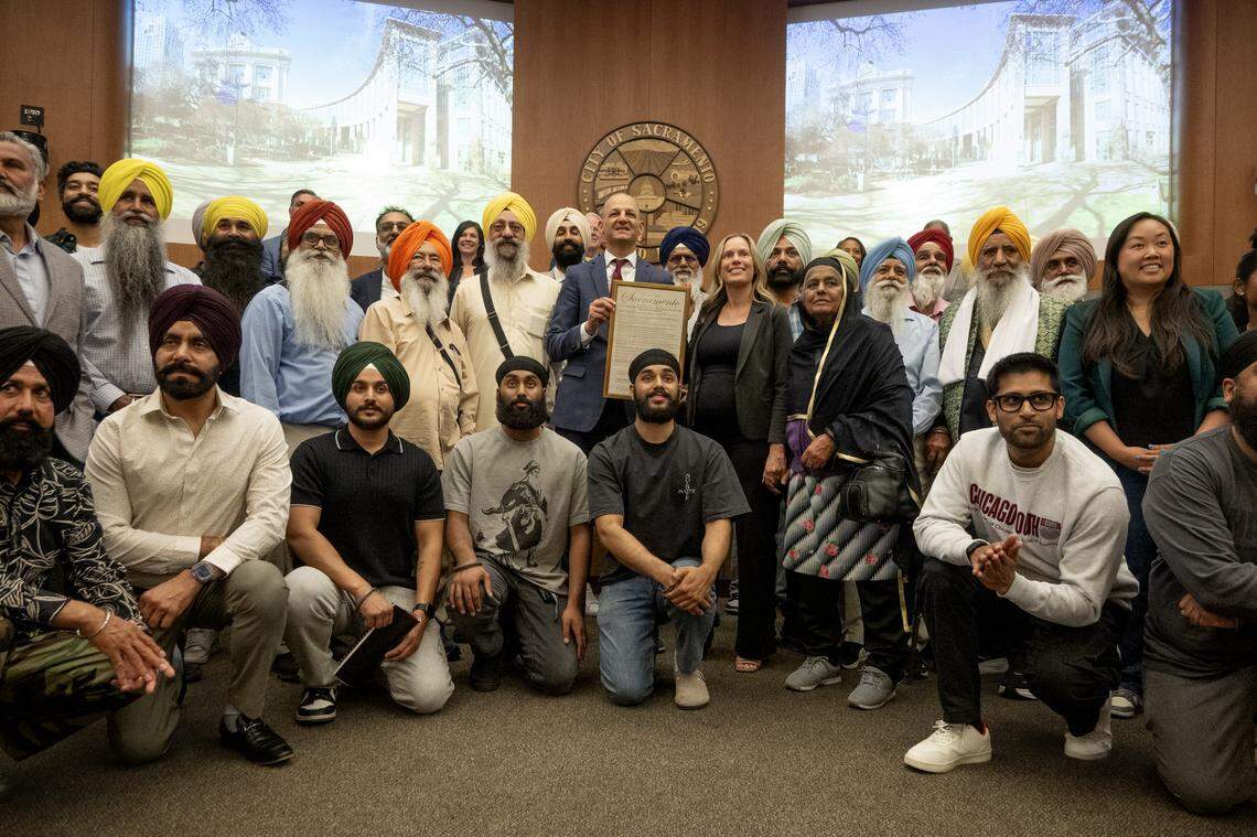 Members of the Sacramento Sikh community pose for a photograph with the Sacramento City Council on Tuesday, the first meeting where religious blades known as kirpans were allowed.