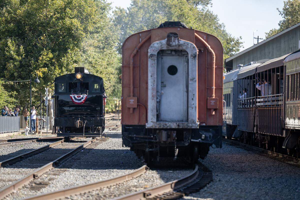The historic Granite Rock 10 steam locomotive, left, is prepared to hook up with the passenger car, center, as the engine officially returned to service Saturday in Old Sacramento.