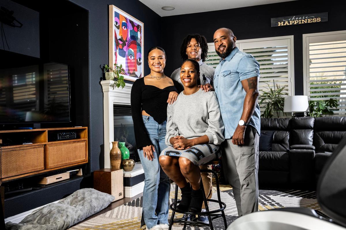 Amber Clark, of Elk Grove is surrounded by her daughter April, left, her son Kanye, and her husband Kareem at their home in Elk Grove earlier this month. Clark was suspended during her first year as principal at Granite Bay High School. She has filed a discrimination claim against the school district, a step that is often considered a precursor to a lawsuit.