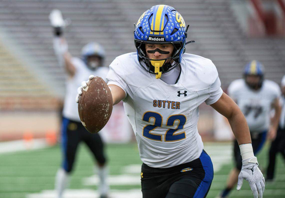 Sutter Huskies running Max Bringgold (22) holds the ball out as he reaches the end zone on a 26-yard reception against the Casa Roble Rams on Nov. 28. He rushed for 142 yards and a touchdown Saturday in Sutter’s 21-7 win over Ferndale in the CIF Northern California Division 4-AA title game.