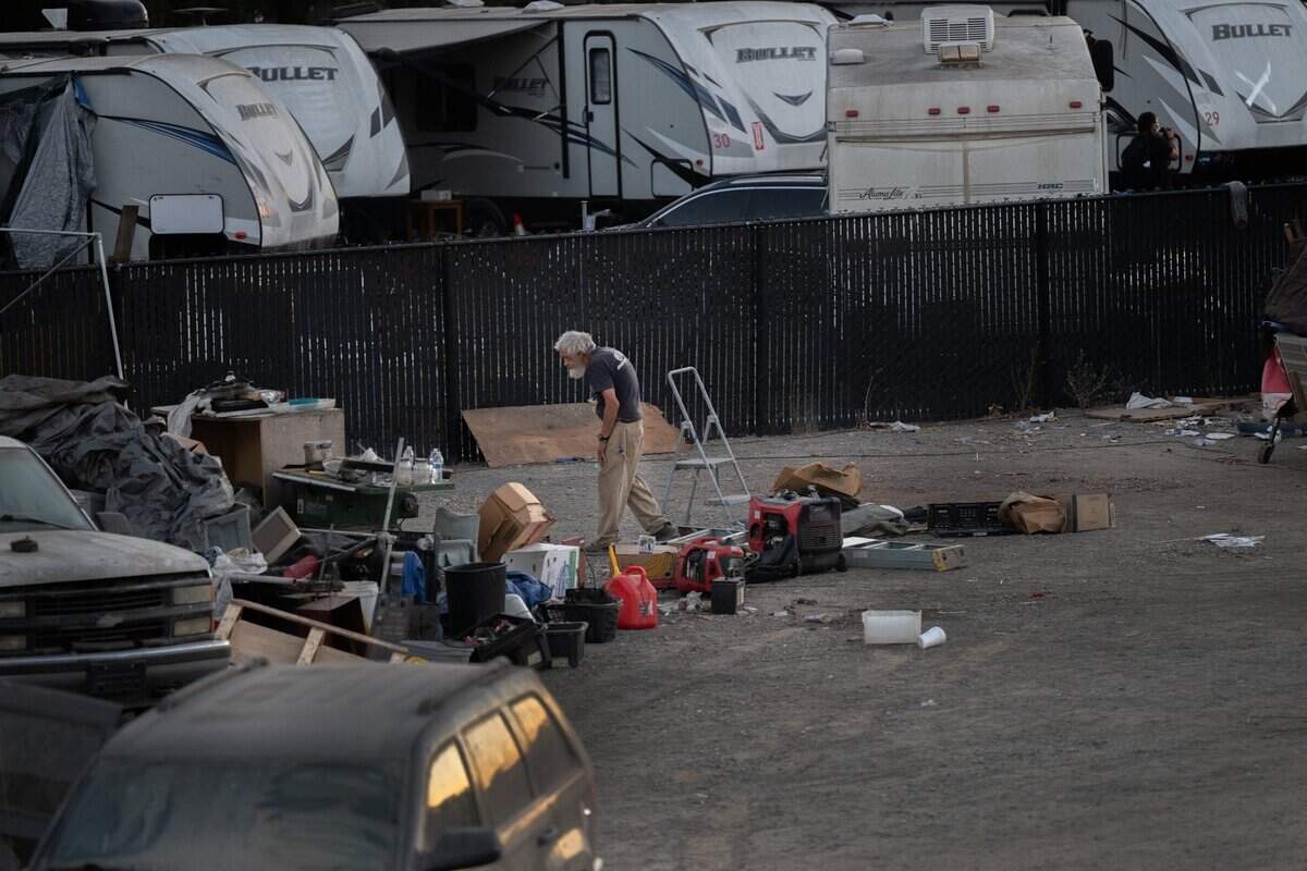William Doyle, 80, looks over his belongings as he decides what he can take as he moves out of Camp Resolution before it was cleared by the city on Sacramento on Monday, Aug. 26, 2024.
