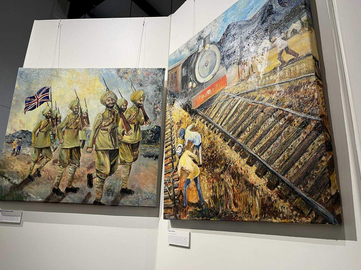 Artwork depicting Punjabi soldiers fighting for Great Britain in World War I, left, and Punjabi railroad workers in Kenya hang in the “Beyond the Five Rivers: Punjabi Pioneers Through the Art of Sarabjit Singh” exhibit at the Sutter County Museum. The temporary exhibit runs through May 9.