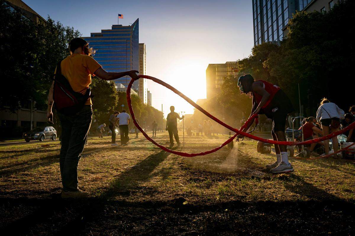 About 100 volunteers help artist Demetris “BAMR” Washington paint “Black Lives Matter” on Capitol Mall on Friday evening, June 5, 2020. The project, which obtained a permit through City Councilman Steve Hansen, spans from Sixth to Ninth streets downtown.