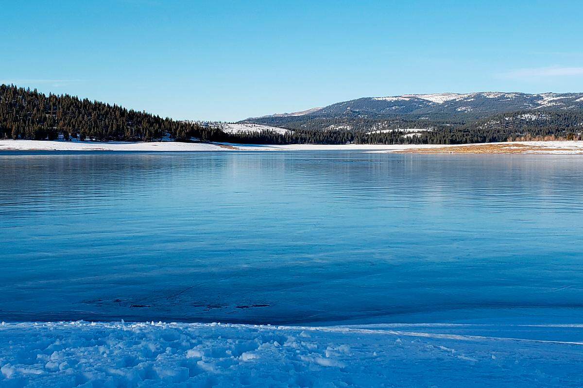 This photo released by the Sierra County Sheriff’s Office shows the Stampede Reservoir in Downieville, Calif., Saturday, Feb. 5, 2022. One person drowned after a group of people fell through the ice while skating at the reservoir north of Lake Tahoe, authorities said. (Holly Bayly/Sierra County Sheriff’s Office via AP)