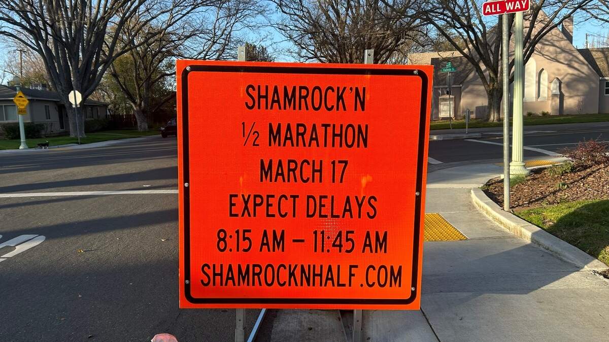 A sign advises residents and motorists that street closures are scheduled for the Shamrock’n half marathon race on Sunday, March 17, 2024.